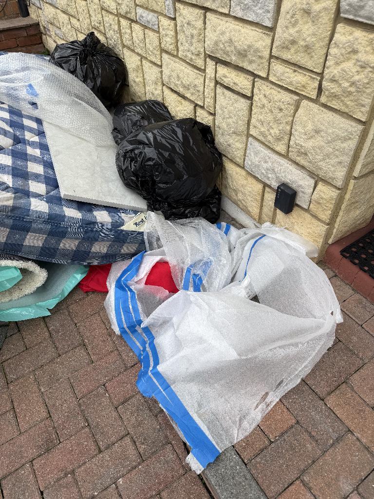 Before u2013 assorted bags and boards on the pavement.
